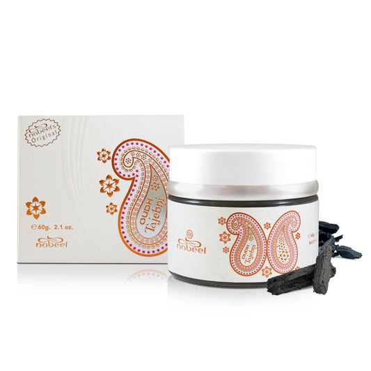 White jar with decorative orange paisley design, packaging, and Nabeel brand logo on a white background