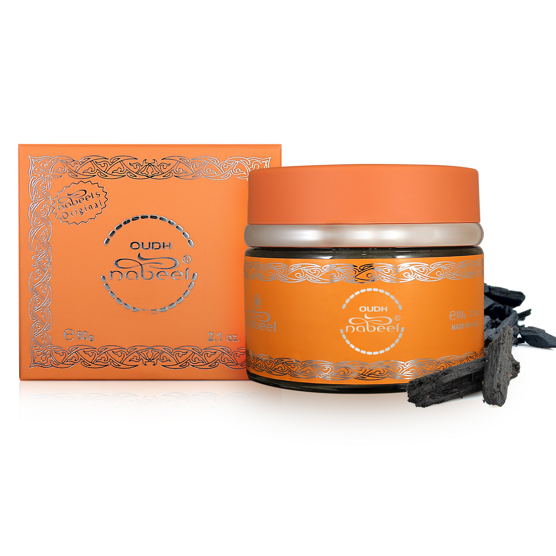 Orange container with silver lid and decorative design, accompanied by a box and black sticks on a white background.