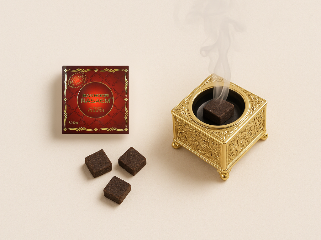 Bakhoor packet and pieces along with a piece of bakhoor burning in a burner with fumes on a light brown background