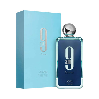 A bottle of Afnan 9 am Dive eau de parfum next to its light blue packaging box, featuring a dark blue label with a large white '9am' and a silver cap.