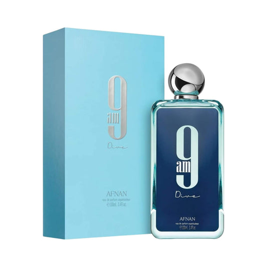 A bottle of Afnan 9 am Dive eau de parfum next to its light blue packaging box, featuring a dark blue label with a large white '9am' and a silver cap.