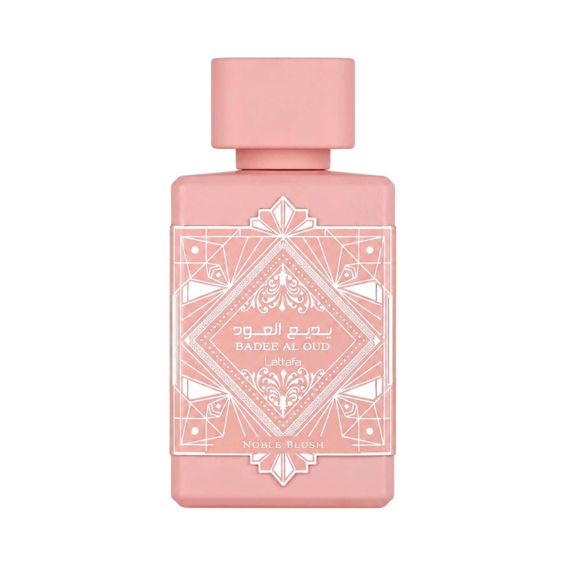 A rectangular pink perfume bottle with a matching pink cap, featuring white geometric and ornamental label detailing. The label reads 'Badee Al Qud' and 'Noble Blush'.