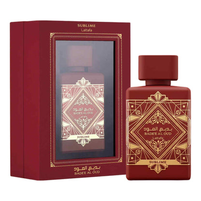 A bottle of Sublime Badee Al Oud perfume next to its red gift box, both decorated with gold geometric patterns and featuring Arabic text.