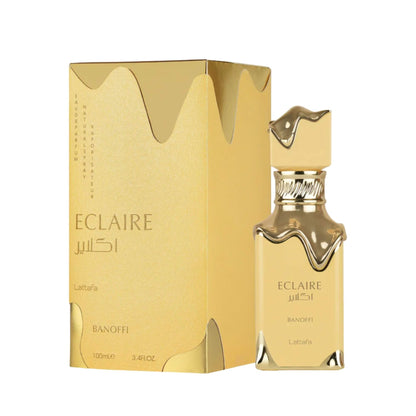 Gold Lattafa Eclaire perfume bottle and packaging on a white background. 