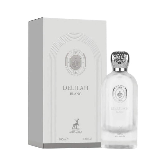 Delilah Blanc perfume bottle with a silver cap next to its white packaging box, featuring the brand name and a deer logo.