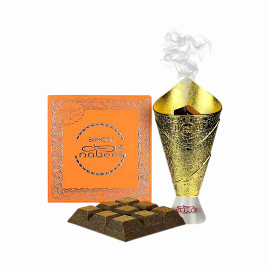 Orange box with a gold bakhoor burner burner behind nine bakhoor tablets infused together on a white background.