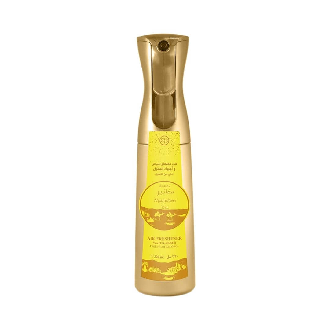 A gold-colored spray bottle of air freshener with a yellow label, shown against a plain white background.