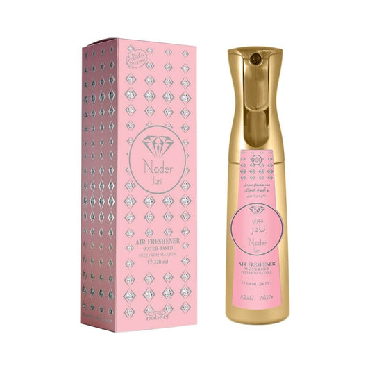 Nader Juri water-based air freshener bottle in gold with a pink label, shown next to its pink packaging box with silver geometric patterns.